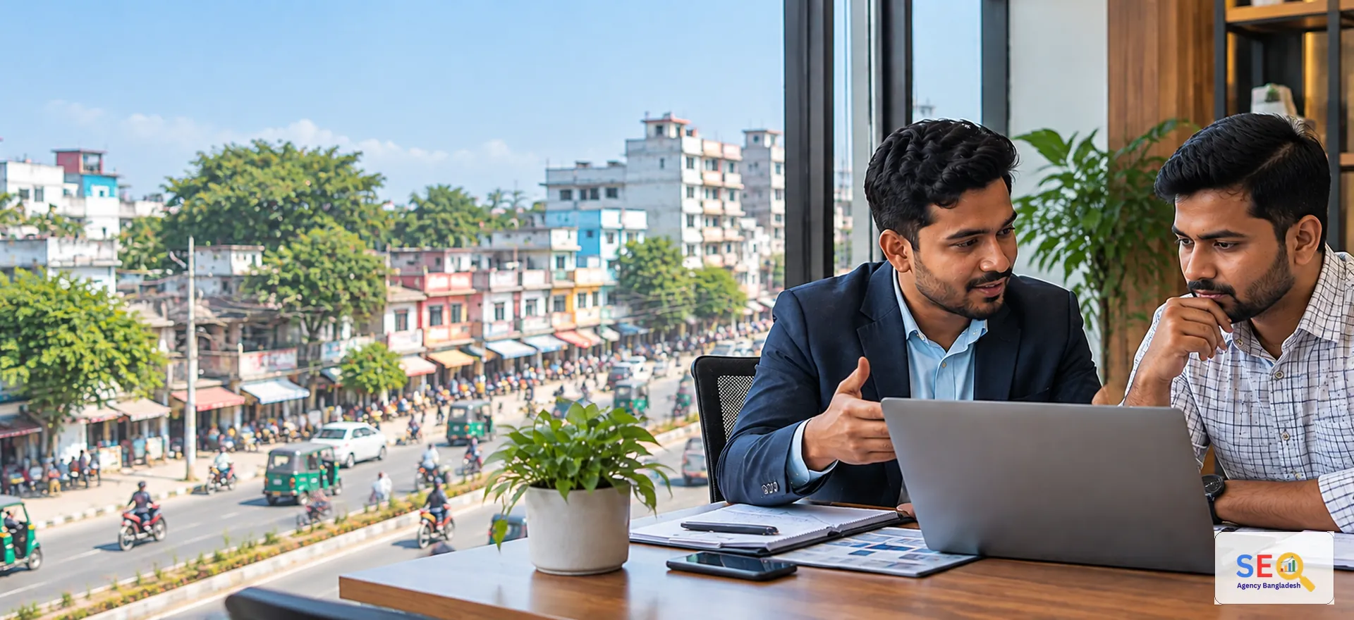 SEO consultant discussing online growth with a business owner in a Pabna commercial setting