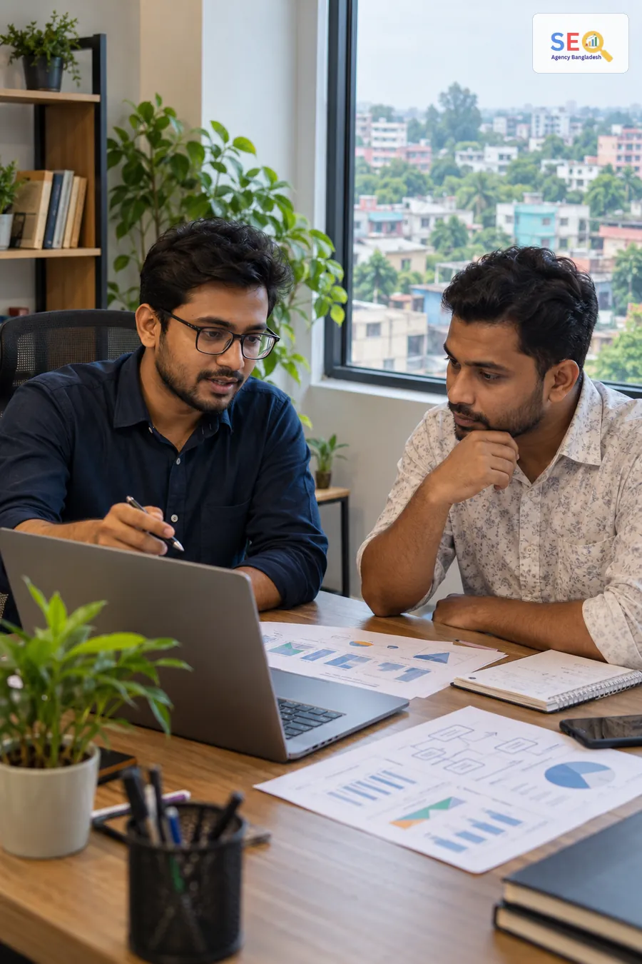 SEO specialist and business owner reviewing website structure, search data and an implementation plan