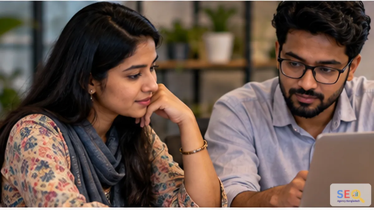 Bangladesh business owners reviewing a WordPress SEO plan on a laptop